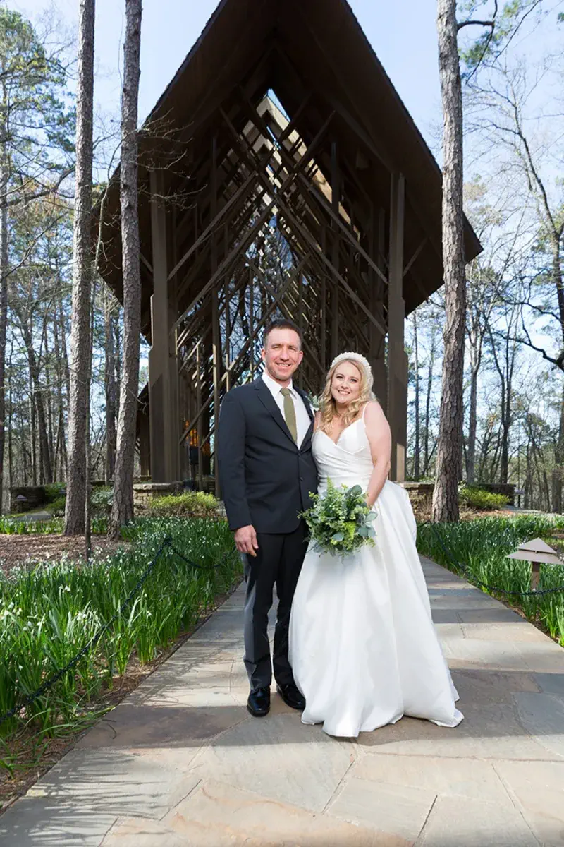 Bride and groom walking a garden pathway at Garvan Woodland Gardens after their Anthony Chapel wedding ceremony