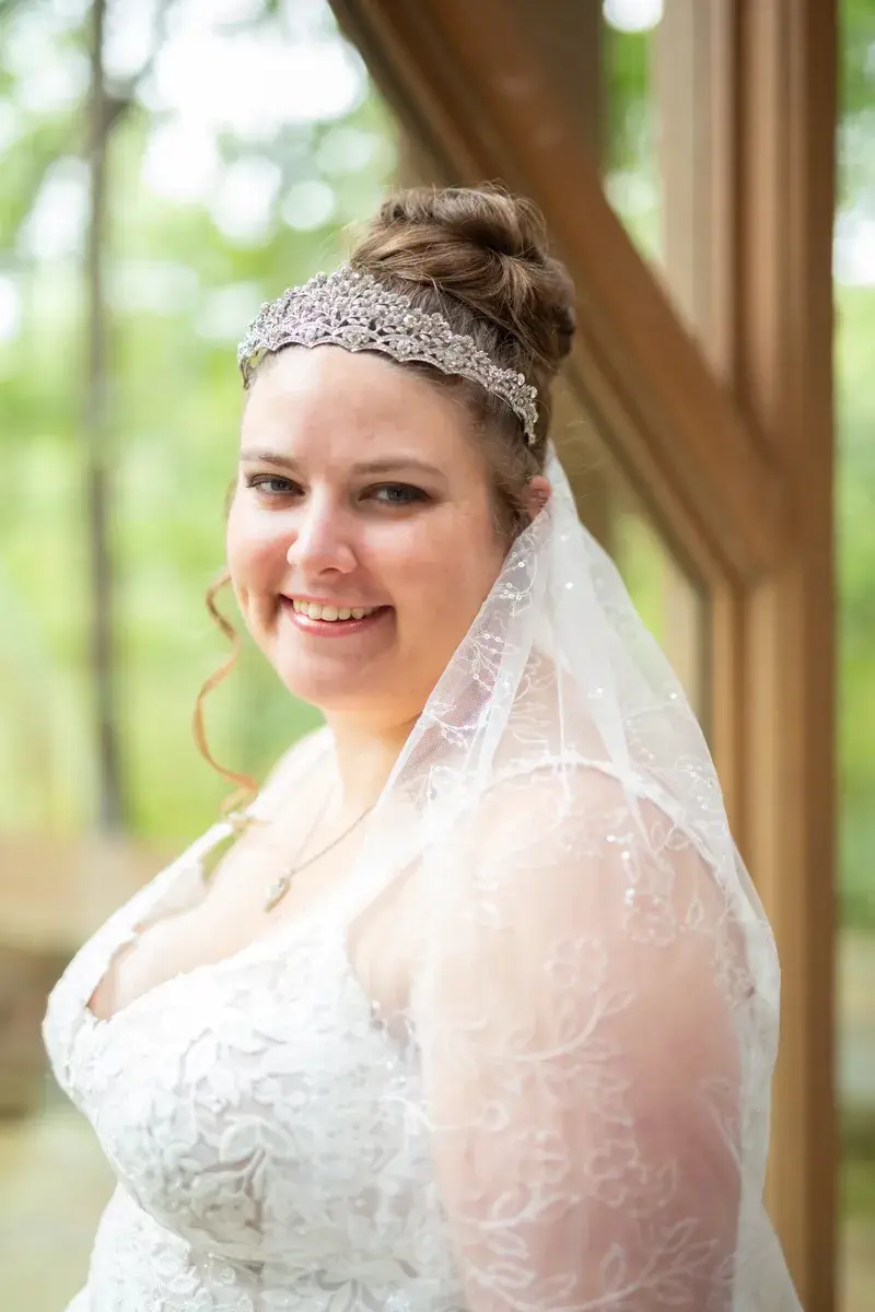 Close-up bridal portrait with Anthony Chapel's glass architecture in the background