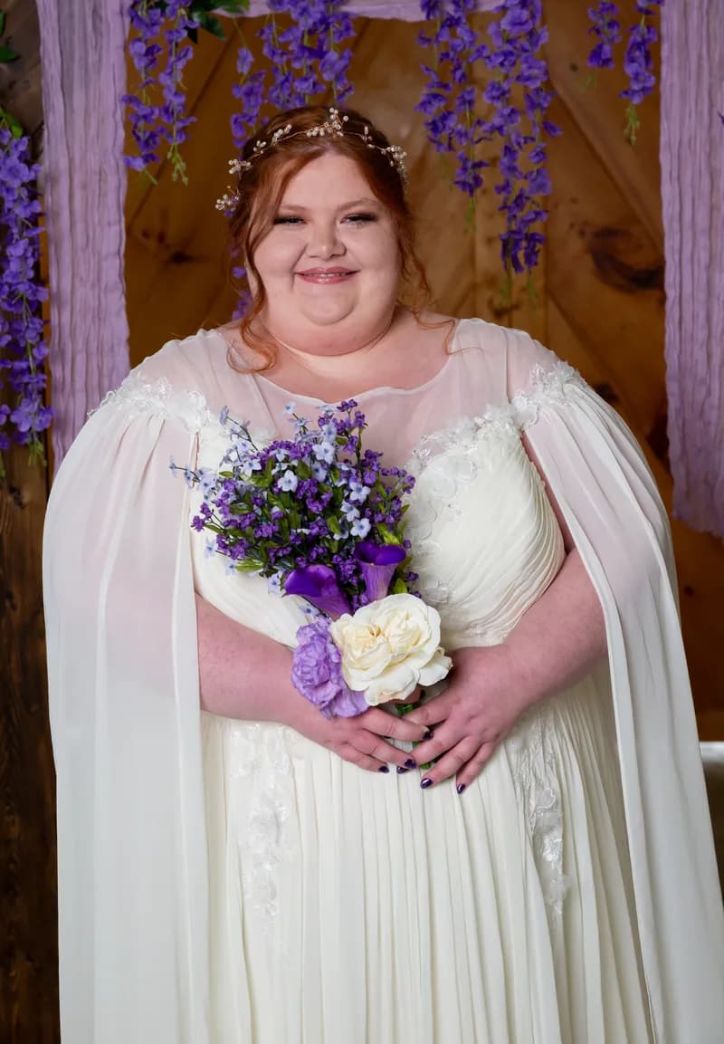 Bride portrait with a purple and white bouquet before her Arkansas wedding ceremony