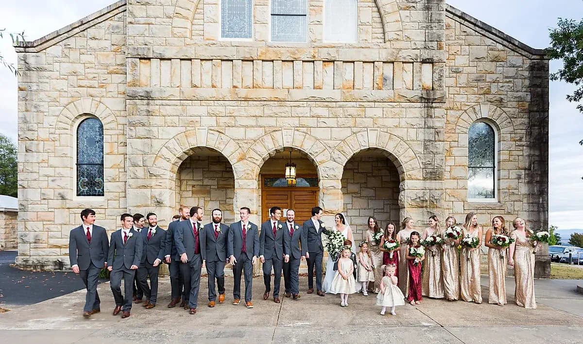 Wedding party outside a stone church